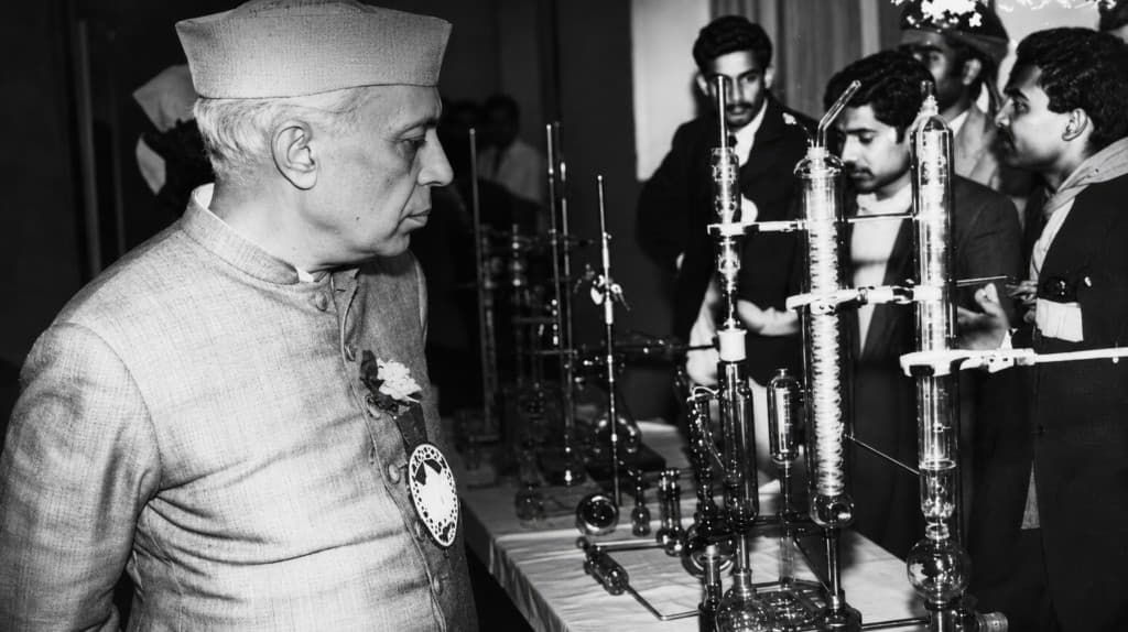 Prime Minister Nehru reviewing laboratory glassware at the Indian Science Congress
