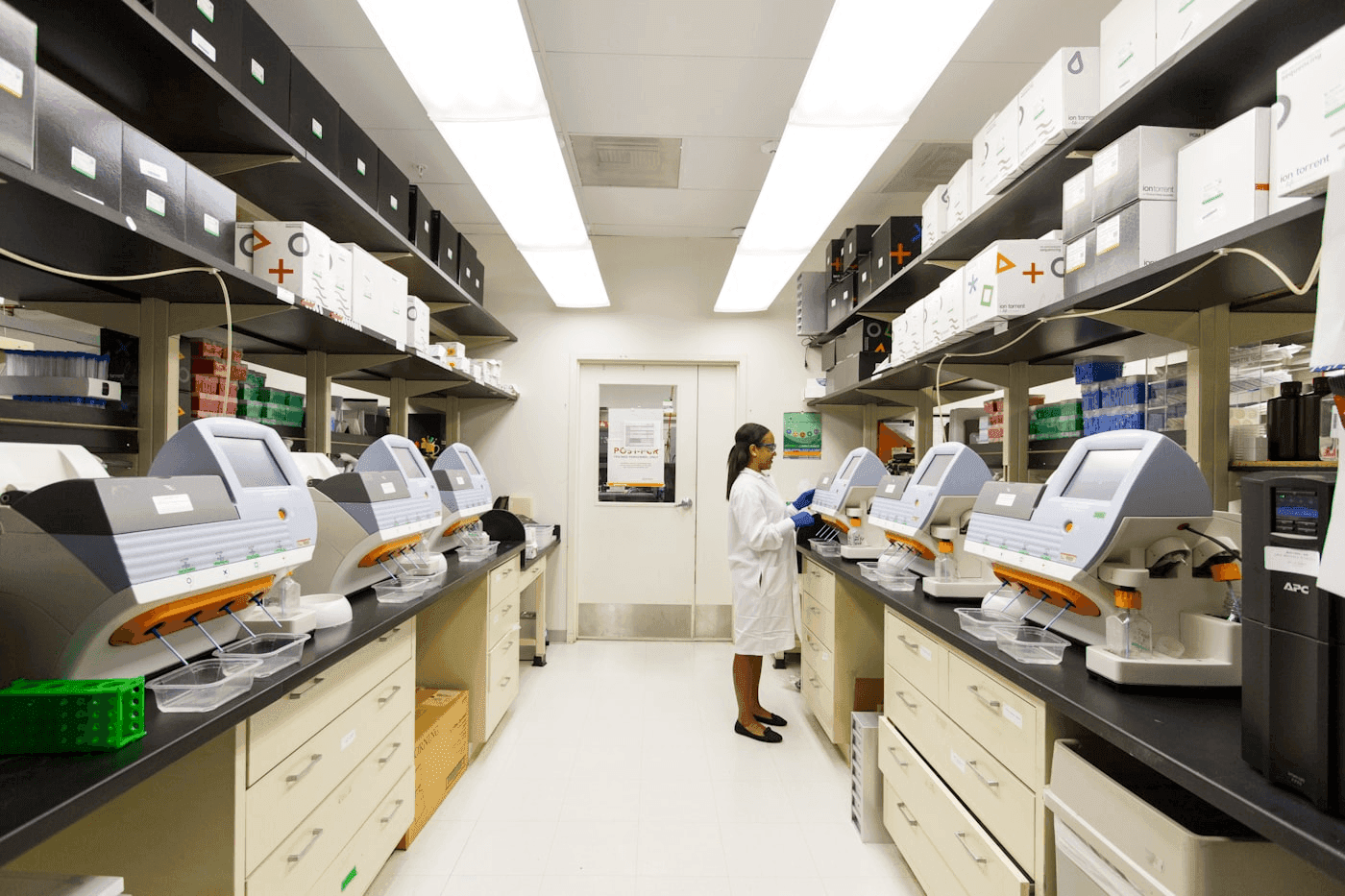 Scientist operating automated laboratory analyzers in a clinical pathology lab
